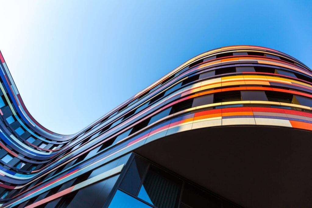 looking up at a colorful building with a blue sky in the background