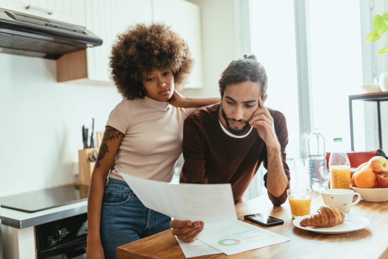 Young couple reviewing an agreement from their financial services provider