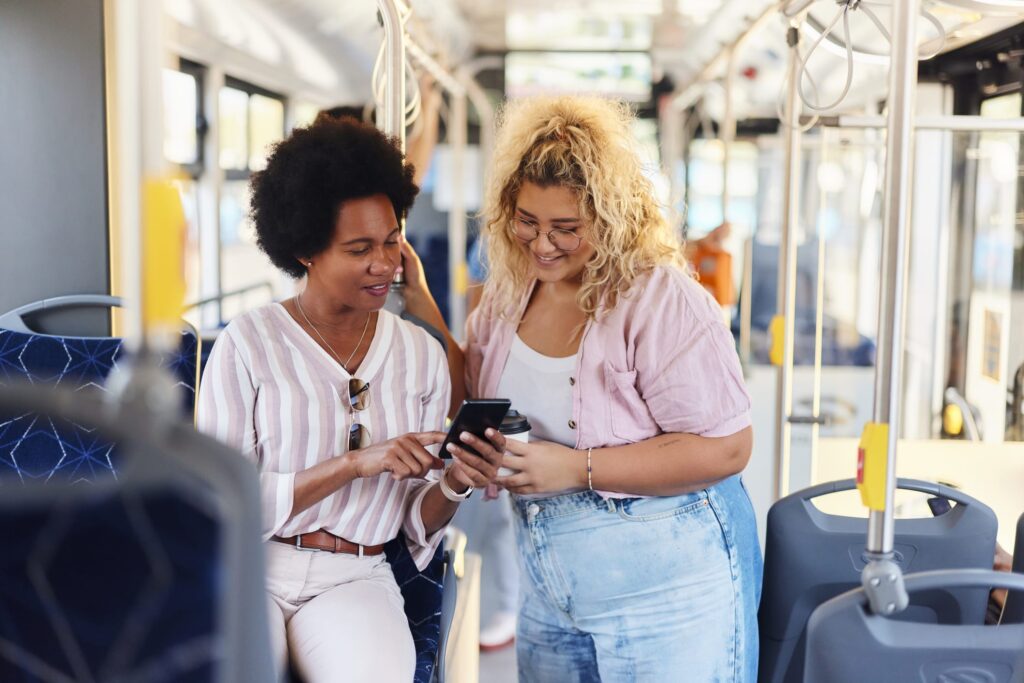 Two bus passengers discuss an advert they have seen