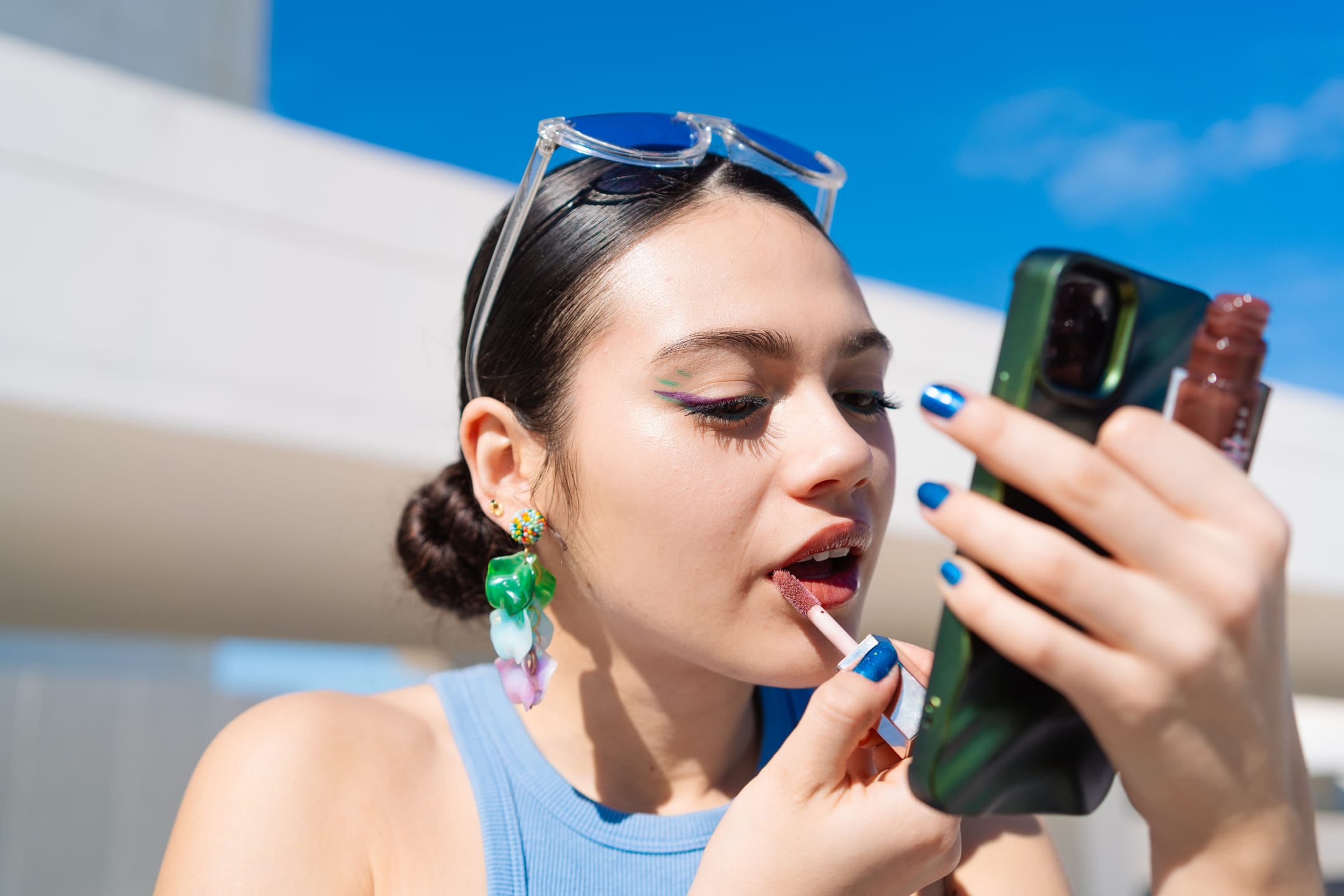 Young Gen Z woman applying make up as part of her beauty routine