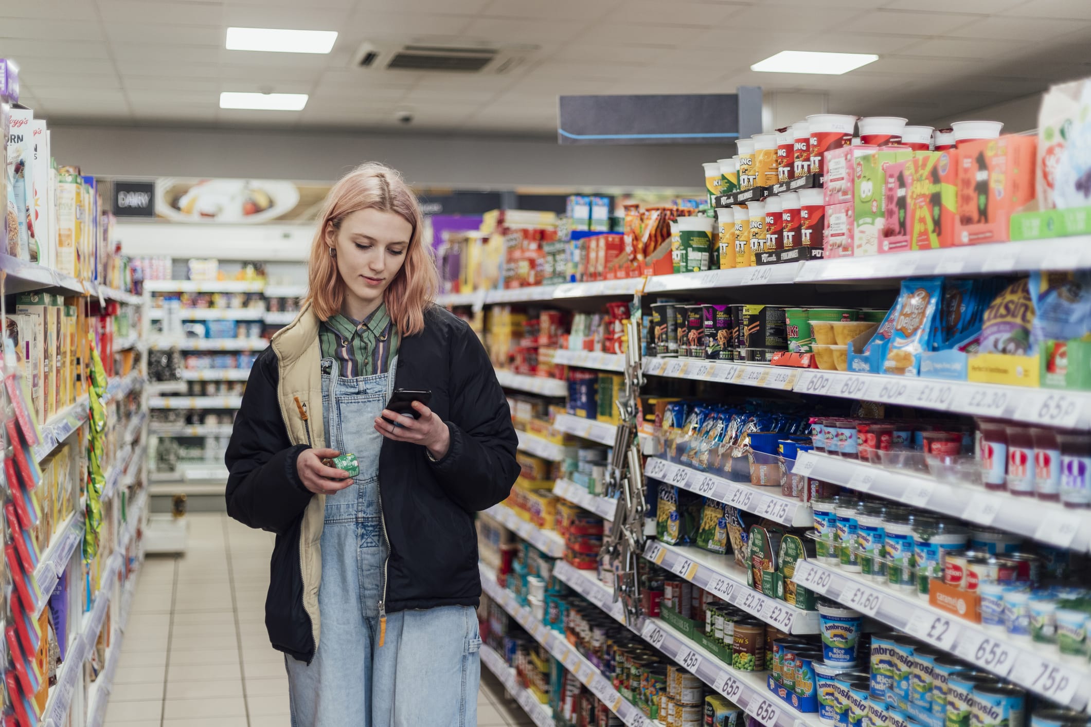 Woman browsing for offers online while in a grocery store