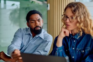 skeptical business professional reviewing documents