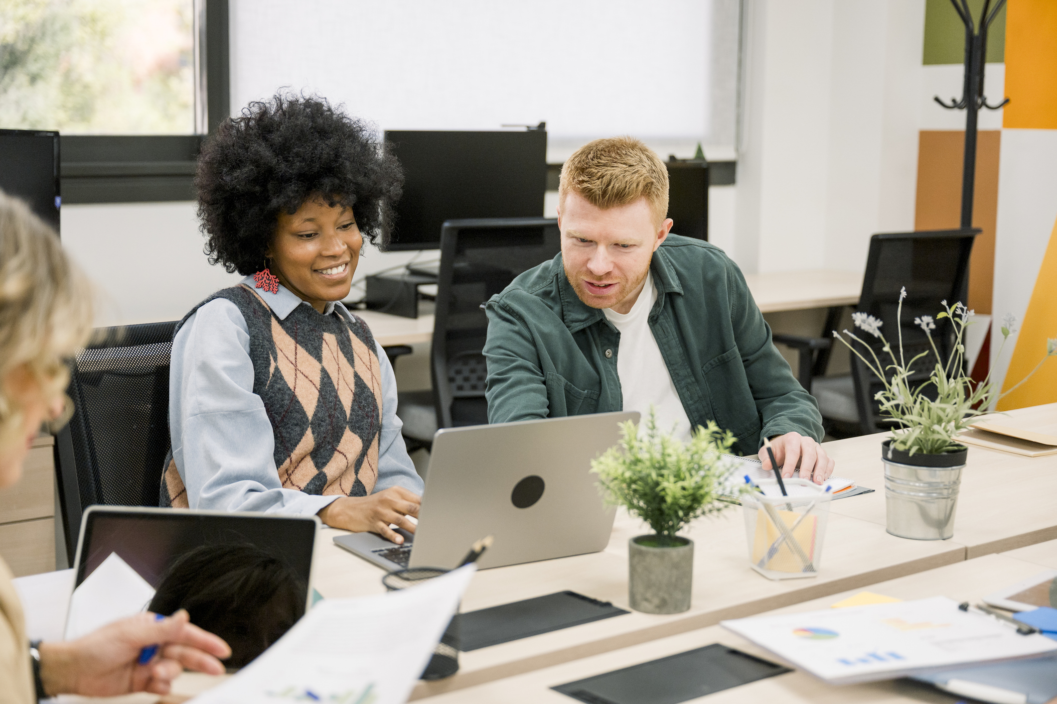 Two colleagues absorbed in something on their computer